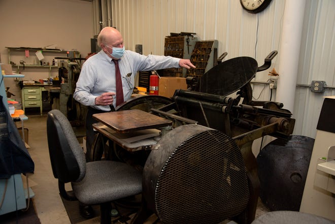 Willie Peterson, co-owner and publisher of The Munising News, on Tuesday, March 30, 2021 demonstrates the 1800's-era printing press that was still be used before the newspaper printed its last edition on Wednesday, March 31, 2021.