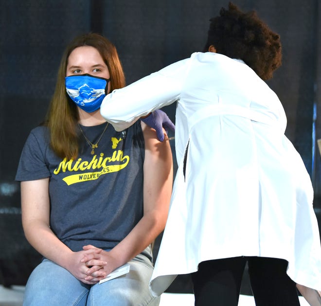 Sherry Shrewsbury receives her first dose of the COVID-19 vaccine from Dr. Joneigh Khaldun.