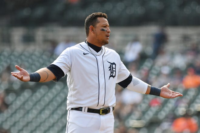 Tigers' Miguel Cabrera talks with someone in the dugout after his at-bat in the eighth inning.