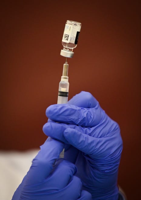Pharmacist Nabilah Seblini fills a syringe with the Johnson & Johnson vaccine