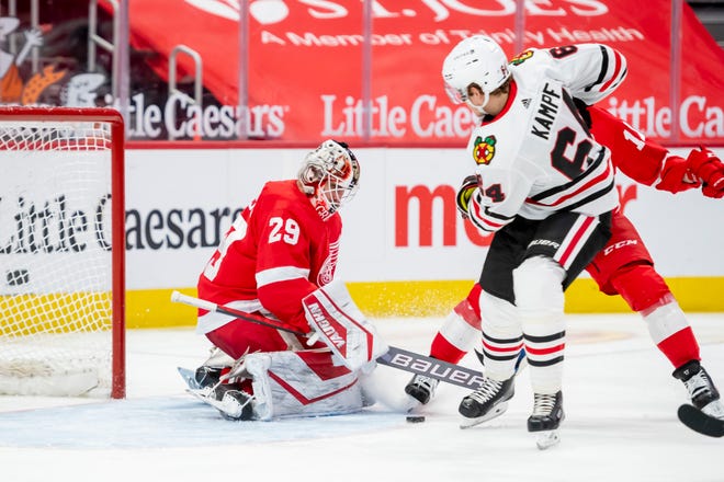 Chicago center David Kampf tries to get the puck past Detroit goaltender Thomas Greiss in the second period during a game between the Detroit Red Wings and the Chicago Blackhawks, at Little Caesars Arena, in Detroit, April 15, 2021.