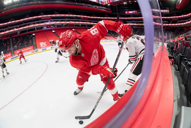 Detroit center Sam Gagner keeps the puck away from Chicago defenseman Duncan Keith in the second period during a game between the Detroit Red Wings and the Chicago Blackhawks, at Little Caesars Arena, in Detroit, April 15, 2021.