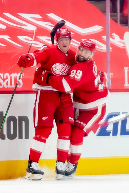 Detroit left wing Jakub Vrana, left, and center Sam Gagner celebrate Vrana's first goal as a Red Wing in the second period during a game between the Detroit Red Wings and the Chicago Blackhawks, at Little Caesars Arena, in Detroit, April 15, 2021.