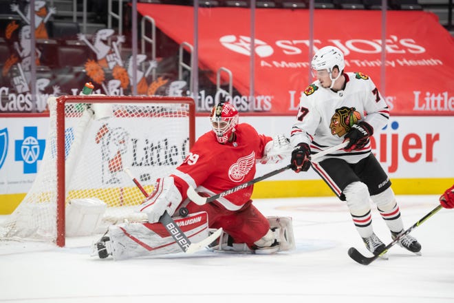 Chicago center Kirby Dach tries to get the puck past Detroit goaltender Thomas Greiss in the second period during a game between the Detroit Red Wings and the Chicago Blackhawks, at Little Caesars Arena, in Detroit, April 15, 2021.