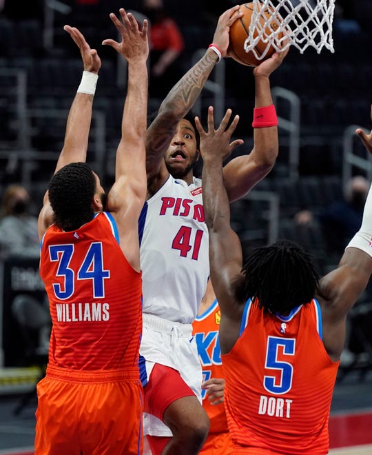 Detroit Pistons forward Saddiq Bey (41) shoots over the defense of Oklahoma City Thunder forwards Kenrich Williams (34) and Luguentz Dort (5) during the second half.