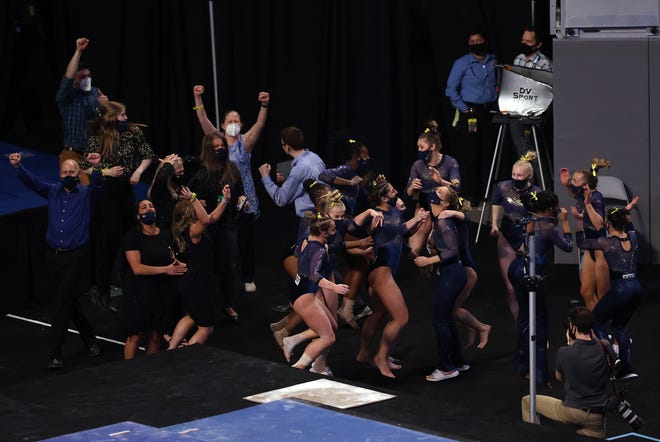 FORT WORTH, TEXAS - APRIL 17: The Michigan Wolverines celebrate after winning the 2021 NCAA Division I Women's Gymnastics Championship at Dickies Arena on April 17, 2021 in Fort Worth, Texas.