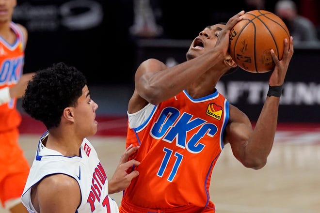 Oklahoma City Thunder guard Theo Maledon (11) is fouled by Detroit Pistons guard Killian Hayes (7) during the first half.