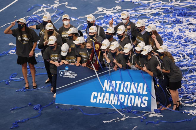 FORT WORTH, TEXAS - APRIL 17: The Michigan Wolverines celebrate after winning the 2021 NCAA Division I Women's Gymnastics Championship.