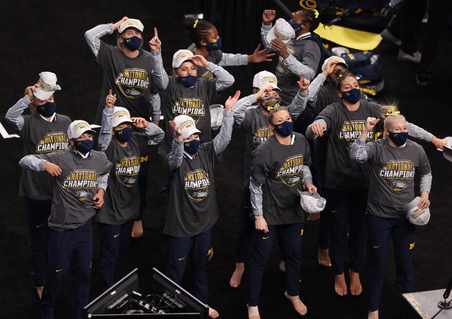 FORT WORTH, TEXAS - APRIL 17: The Michigan Wolverines celebrate after winning the 2021 NCAA Division I Women's Gymnastics Championship.