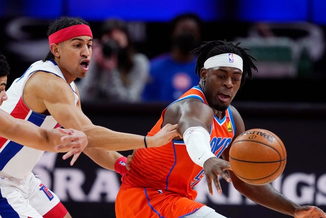 Detroit Pistons guards Killian Hayes, left, Frank Jackson and Oklahoma City Thunder forward Luguentz Dort, right, reach for the loose ball during the second half.