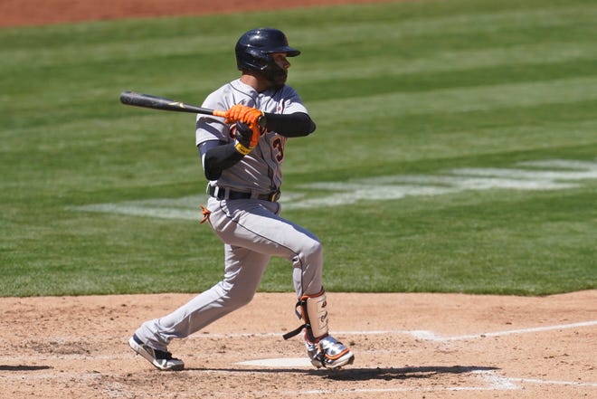 The Tigers' Harold Castro hits a two-run single against the Athletics during the sixth inning.