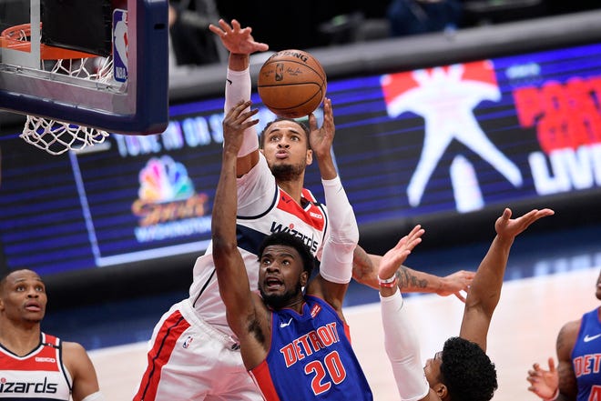 Detroit Pistons guard Josh Jackson (20) goes to the basket against Washington Wizards center Daniel Gafford, back, during the second half.