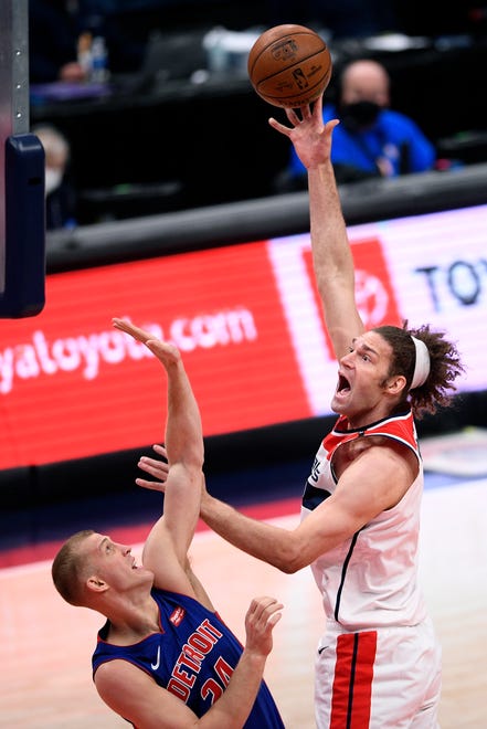 Washington Wizards center Robin Lopez, right, shoots against Detroit Pistons center Mason Plumlee, left, during the first half.