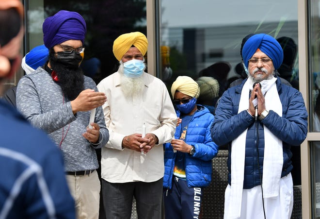 Bhai Iqbar Singh, right, offers a prayer Sunday at a Sikh solidarity vigil at Plymouth Gurdwara Sahib.