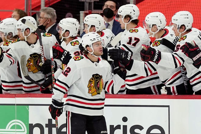 Chicago Blackhawks left wing Alex DeBrincat greets teammates after scoring during the second period.