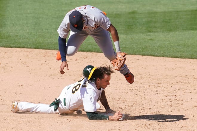 Oakland Athletics' Matt Olson, bottom, is safe at second base under Detroit Tigers shortstop Willi Castro during the ninth inning.
