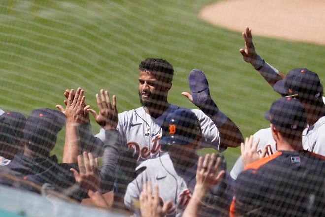 The Tigers' Willi Castro, middle, is congratulated by teammates after scoring in the sixth inning.