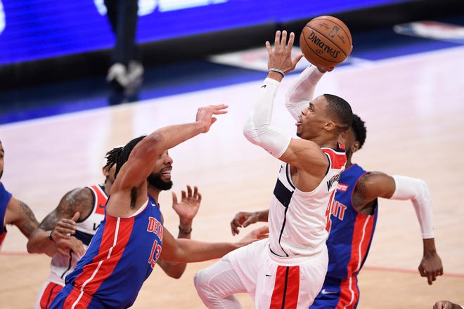 Washington Wizards guard Russell Westbrook, right, goes to the basket against Detroit Pistons center Jahlil Okafor, left, during the first half.