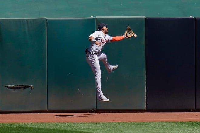 Tigers center fielder Victor Reyes cannot catch a run-scoring triple hit by the Athletics' Ramon Laureano during the fourth inning.
