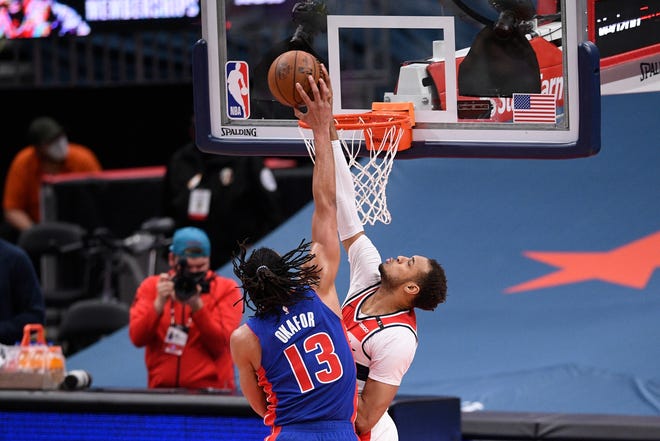 Detroit Pistons center Jahlil Okafor, left, is blocked by Washington Wizards center Daniel Gafford, right, during the first half.