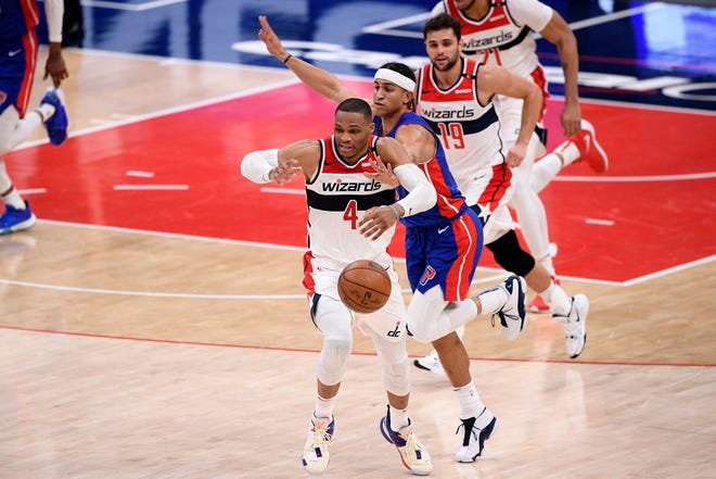 Washington Wizards guard Russell Westbrook (4) is fouled by Detroit Pistons guard Frank Jackson, right, during the first half.