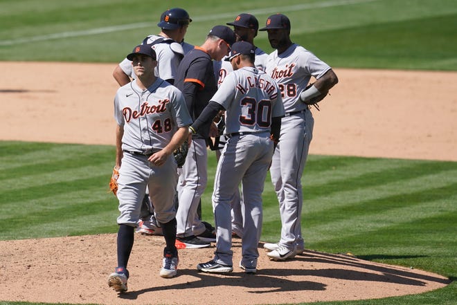 Detroit Tigers pitcher Matthew Boyd (48) walks off the mound after being taken out for a relief pitcher by manager A.J. Hinch, center, during the eighth inning.