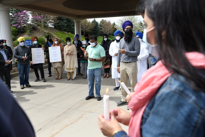 People from the Sikh community and others hold candles at a solidarity vigil at Plymouth Gurdwara Sahib.