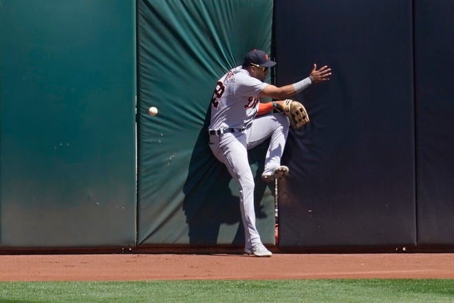Tigers center fielder Victor Reyes cannot catch a run-scoring triple hit by the Athletics' Ramon Laureano during the fourth inning.