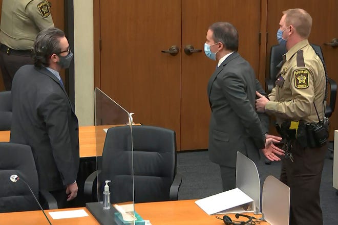 In this image from video, former Minneapolis police officer Derek Chauvin is taken into custody as his attorney Eric Nelson, left, watches, after his bail was revoked after he was found guilty on all three counts in his trial for the 2020 death of George Floyd, Tuesday, April 20, 2021, at the Hennepin County Courthouse in Minneapolis.
