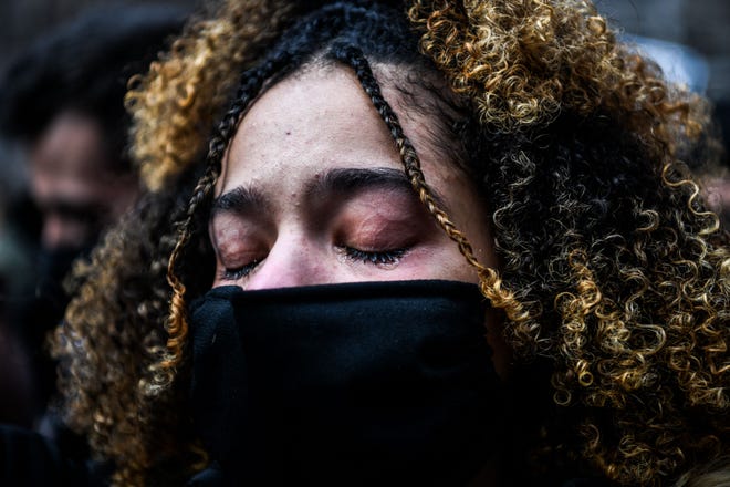 A woman cries as the verdict is announced in the trial of former police officer Derek Chauvin outside the Hennepin County Government Center in Minneapolis, Minnesota on April 20, 2021. - Sacked police officer Derek Chauvin was convicted of murder and manslaughter on april 20 in the death of African-American George Floyd in a case that roiled the United States for almost a year, laying bare deep racial divisions.