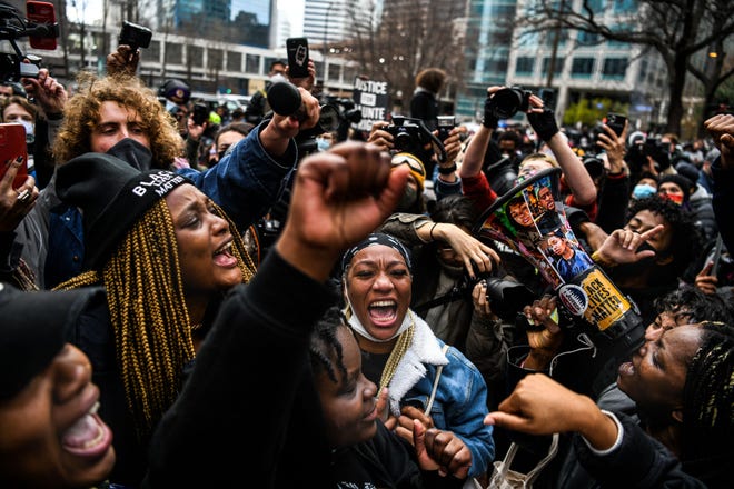 People celebrate as the verdict is announced in the trial of former police officer Derek Chauvin outside the Hennepin County Government Center in Minneapolis, Minnesota on April 20, 2021. - Sacked police officer Derek Chauvin was convicted of murder and manslaughter on april 20 in the death of African-American George Floyd in a case that roiled the United States for almost a year, laying bare deep racial divisions.