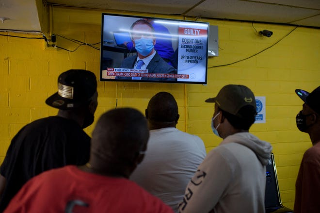 People gather inside the Twees Foods Store in the Third Ward where George Floyd grew up in Houston, Texas, to watch the the verdict in Derek Chauvin's trial on April 20, 2021. - Sacked police officer Derek Chauvin was convicted of murder and manslaughter on april 20 in the death of African-American George Floyd in a case that roiled the United States for almost a year, laying bare deep racial divisions.