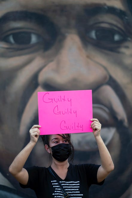 A woman holds up a "Guilty" sign during a gathering and march in Atlanta, Tuesday, April 20, 2021, after former Minneapolis police Officer Derek Chauvin was found guilty on all counts in the death of George Floyd.