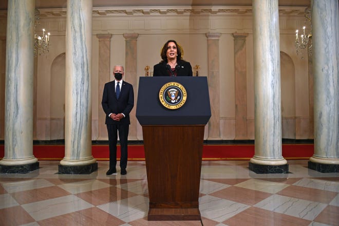 US President Joe Biden (L) listens as Vice President Kamala Harris delivers remarks on the guilty verdict against former policeman Derek Chauvin at the White House in Washington, DC, on April 20, 2021. - Derek Chauvin, a white former Minneapolis police officer, was convicted on April 20 of murdering African-American George Floyd after a racially charged trial that was seen as a pivotal test of police accountability in the United States.