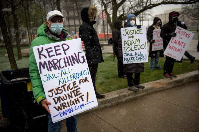 Michael Mulholland of Detroit holds a sign during the gathering arranged by Detroit Will Breathe after Derek Chauvin was found guilty of second-degree murder, third-degree murder and second-degree manslaughter at the corner of Michigan and Third Avenues in Detroit, Mich. on April 20, 2021.