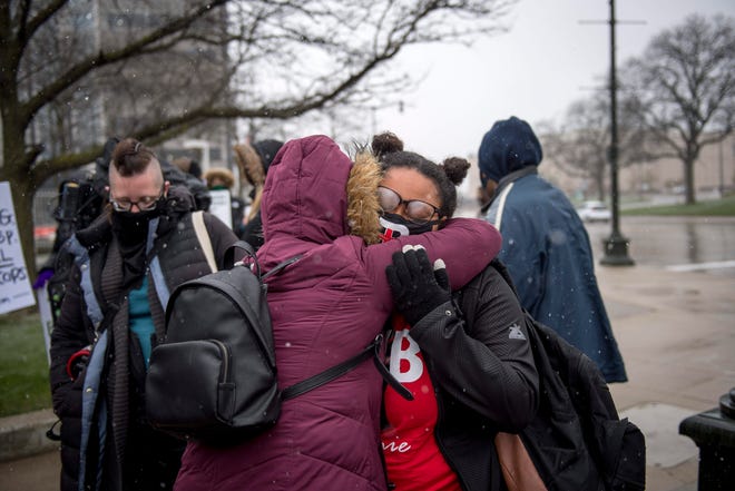 Detroit Will Breathe member Sammie Lewis embraces a friend during the gathering arranged by Detroit Will Breathe after Derek Chauvin was found guilty of second-degree murder, third-degree murder and second-degree manslaughter at the corner of Michigan and Third Avenues in Detroit, Mich. on April 20, 2021.