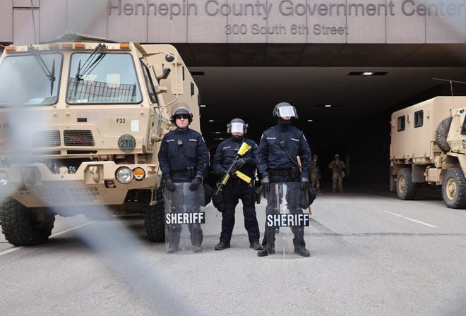 Police stand guard outside the Hennepin County Government Center as people await the verdict in the Derek Chauvin trial on April 20, 2021 In Minneapolis, Minnesota. Former police officer Derek Chauvin is on trial on second-degree murder, third-degree murder and second-degree manslaughter charges in the death of George Floyd May 25, 2020.  After video was released of then-officer Chauvin kneeling on Floyd's neck for nine minutes and twenty-nine seconds, protests broke out across the U.S. and around the world.