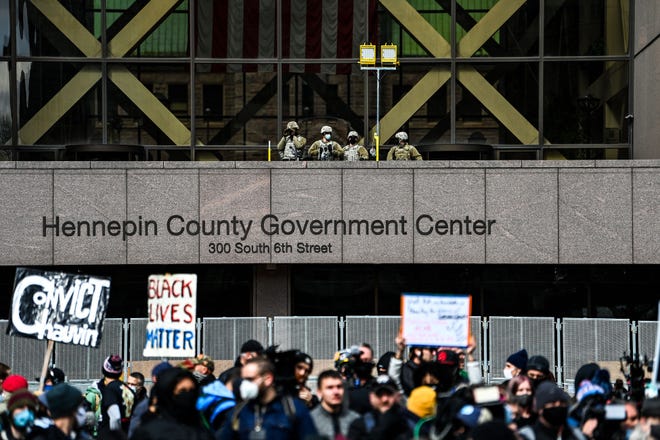 Members of the National Guards and other Law enforcement officers stand guard outside the Hennepin County Government Center as the verdict is announced in the trial of former police officer Derek Chauvin in Minneapolis, Minnesota on April 20, 2021. - Sacked police officer Derek Chauvin was convicted of murder and manslaughter on april 20 in the death of African-American George Floyd in a case that roiled the United States for almost a year, laying bare deep racial divisions.