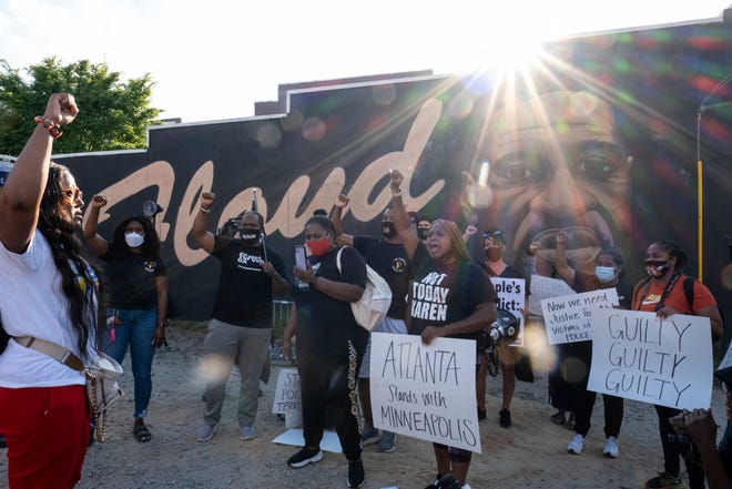 People gather before a march in Atlanta, Tuesday, April 20, 2021, after former Minneapolis police Officer Derek Chauvin was found guilty on all counts in the death of George Floyd.