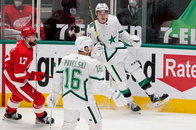Detroit Red Wings defenseman Filip Hronek (17) skates past as Dallas Stars center Joe Pavelski (16) and left wing Jason Robertson (21) celebrate a goal scored by Robertson in the first period of an NHL hockey game in Dallas, Tuesday, April 20, 2021.