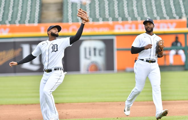Tigers second baseman Willi Castro catches a popup being watched by shortstop Niko Goodrum, right, in the first inning.