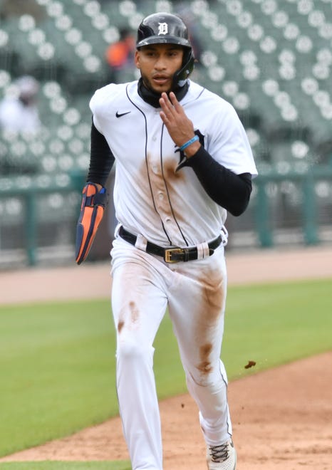 The Tigers' Victor Reyes scores on a sacrifice fly in the third inning.
