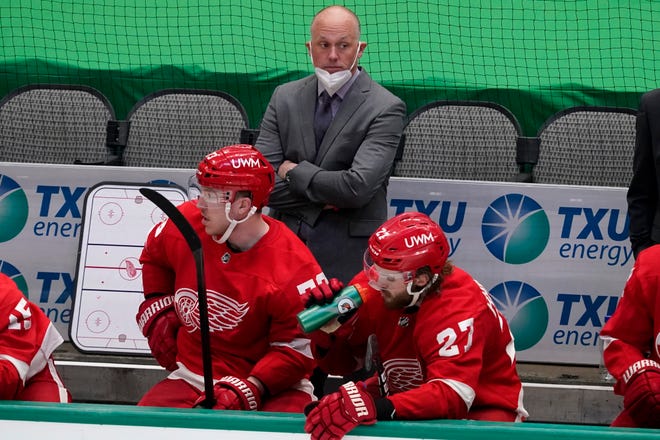 Detroit Red Wings head coach Jeff Blashill, rear, Adam Erne (73) and Michael Rasmussen (27) watch play against the Dallas Stars in the third period of an NHL hockey game in Dallas, Tuesday, April 20, 2021.