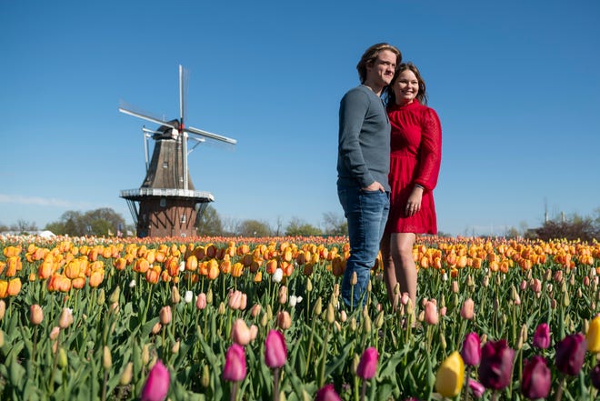 Matthew Marek, left, and Cameryn Fallon, of Belleville, have their photograph taken at the tulip fields at Windmill Island Gardens park, in Holland, April 29, 2021.