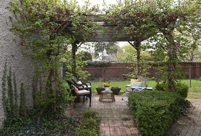 A lush pergola/patio is the perfect perch for relaxing with a cup of coffee or glass of wine.