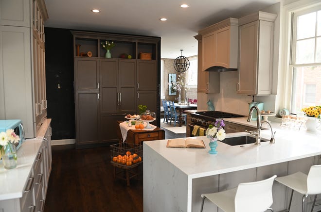 The newer kitchen features a comfortable breakfast counter and a hidden refrigerator