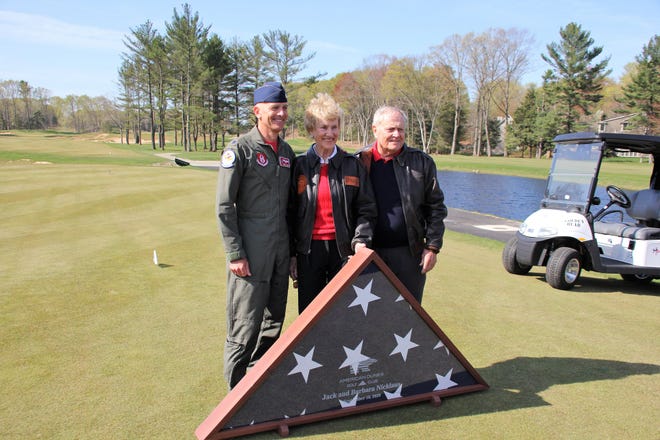 Lt. Col. Dan Rooney with Barbara and Jack Nicklaus during the opening ceremonies, at which the Nicklauses were presented with a flag.