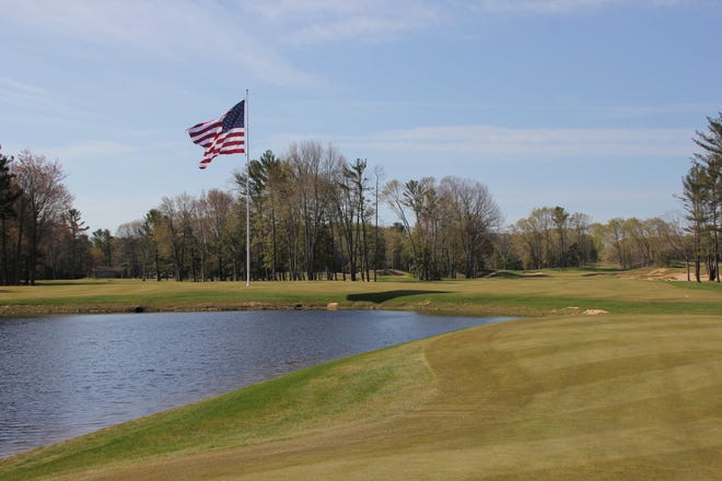 The massive American flag sits between the ninth green and 10th tee.