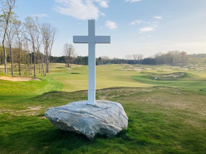 A cross sits between the 17th green and 18th tee, in a tribute to fallen fighter pilots. Golfers are asked to toss a nickel on the grass, tradition at the gravesites of fallen fighter pilots.