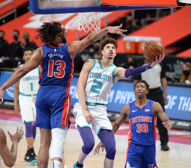 Hornets' LaMelo Ball shoots over Pistons' Jahlil Okafor in the first quarter.